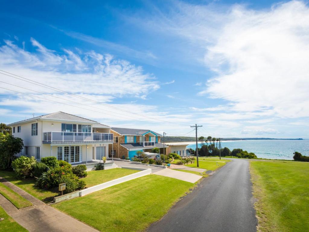 a house on a street with a view of the ocean at 31 McMillan Crescent, Dalmeny in Dalmeny
