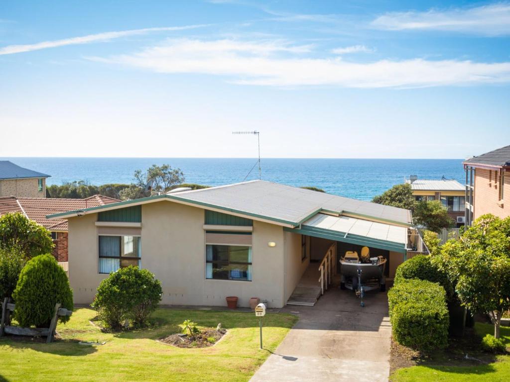 a house with a view of the ocean at Kianga Parade Beach House in Kianga