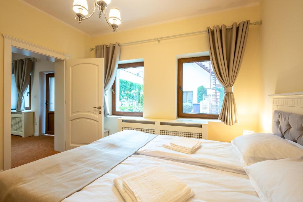 Postel nebo postele na pokoji v ubytování Apartament Hotel H