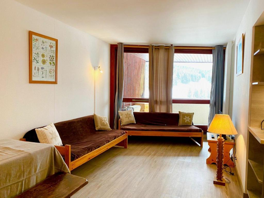 a room with a bed and a couch and a window at Appartement Villard-de-Lans, 3 pièces, 7 personnes - FR-1-515-6 in Villard-de-Lans