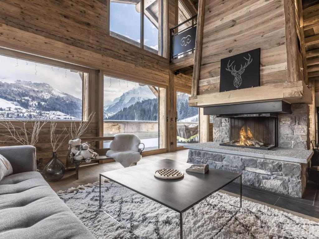 a living room with a couch and a fireplace at Chalet La Clusaz, 5 pièces, 11 personnes - FR-1-304-229 in La Clusaz