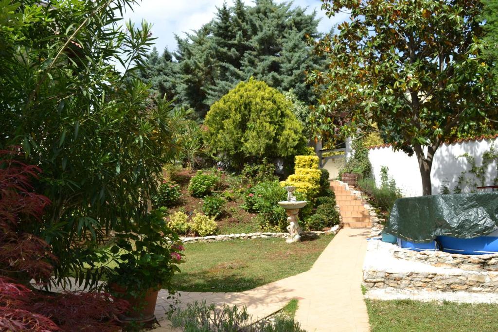 a garden with a path and trees and bushes at Villa Verde Apartments and Rooms in Premantura