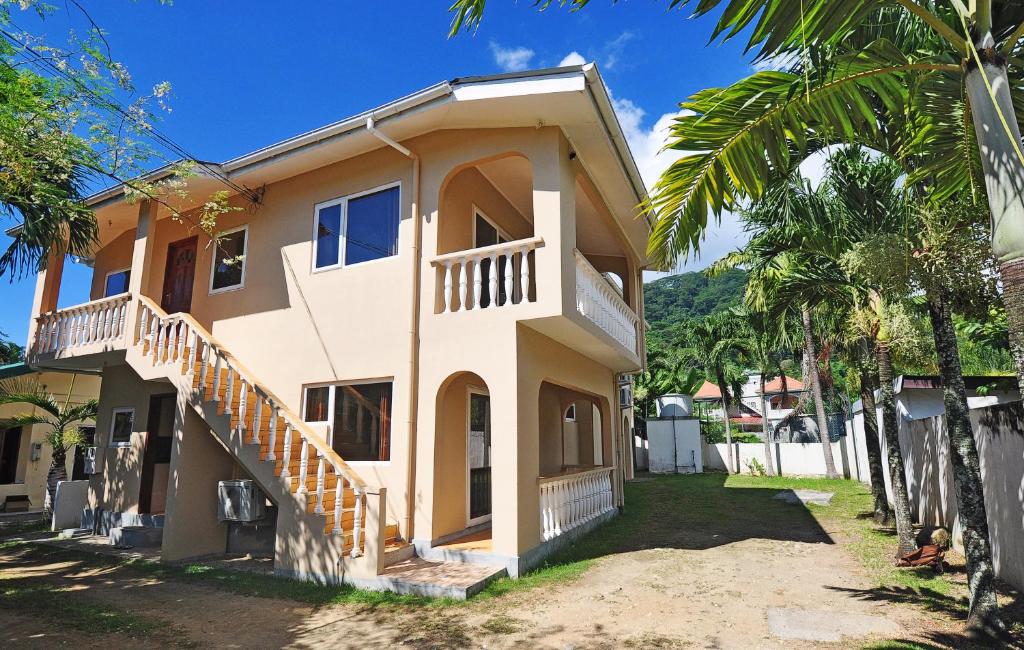 a house with a staircase on the side of it at GT Self Catering Apartments in Beau Vallon
