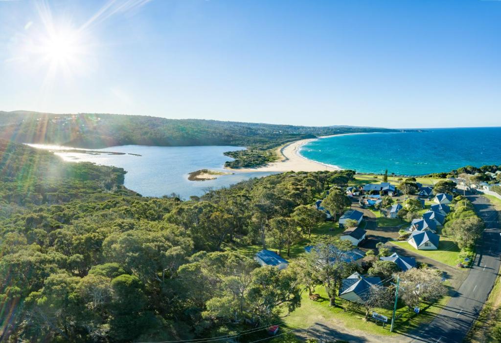 a scenic view of a beach with a large body of water at Beach Cabins Merimbula in Merimbula