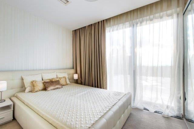 a bedroom with a large bed and a large window at White Luxury Villa Esztergom in Esztergom