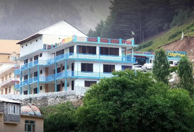 a blue and white building on top of a hill at Clifton Hotel Naran in Naran