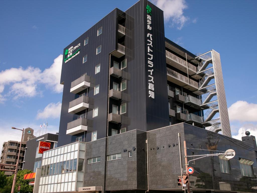 a tall black building with a sign on it at Hotel Best Price Kochi in Kochi