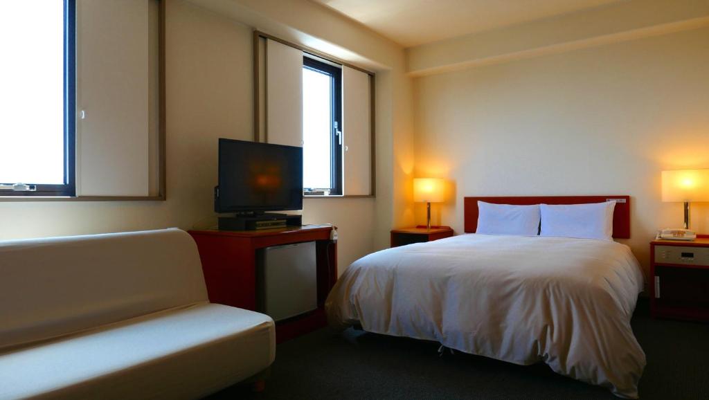 Postel nebo postele na pokoji v ubytování Tourist Hotel Hitachi