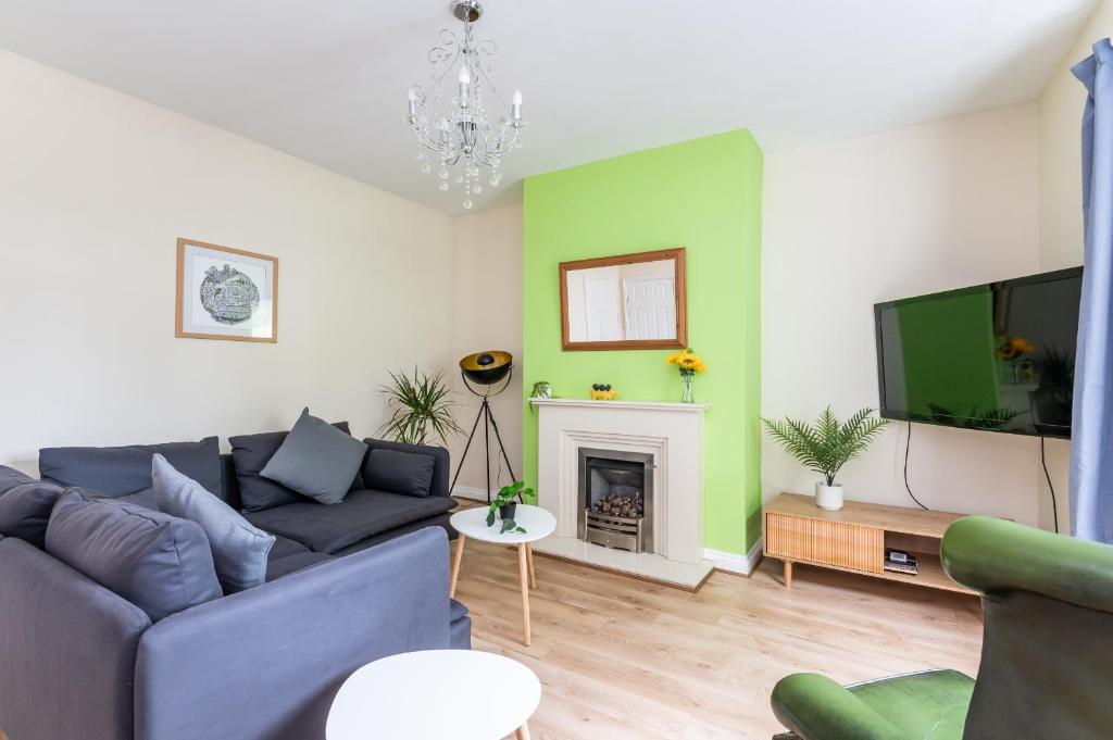 a living room with a couch and a tv at Cosy Home with York Minster Views - Pass the Keys in York