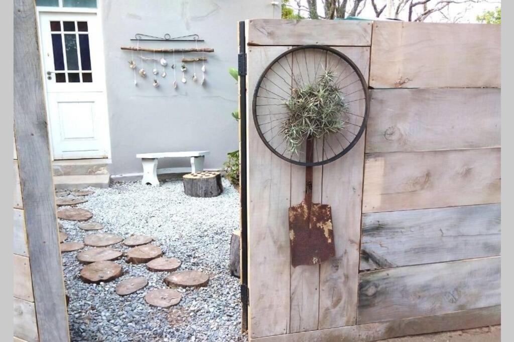 a wooden fence with a bicycle on top of it at The Homestead - Simple Farm-Style Accommodation in Port Alfred