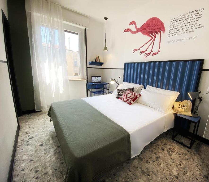 a bedroom with a large bed with a red lizard on the wall at YellowSquare Milan in Milan