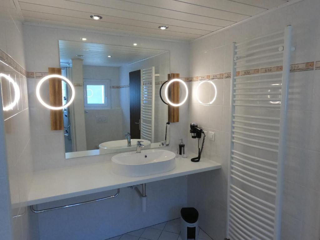 a bathroom with a sink and a mirror at Hotel Eden in Grächen