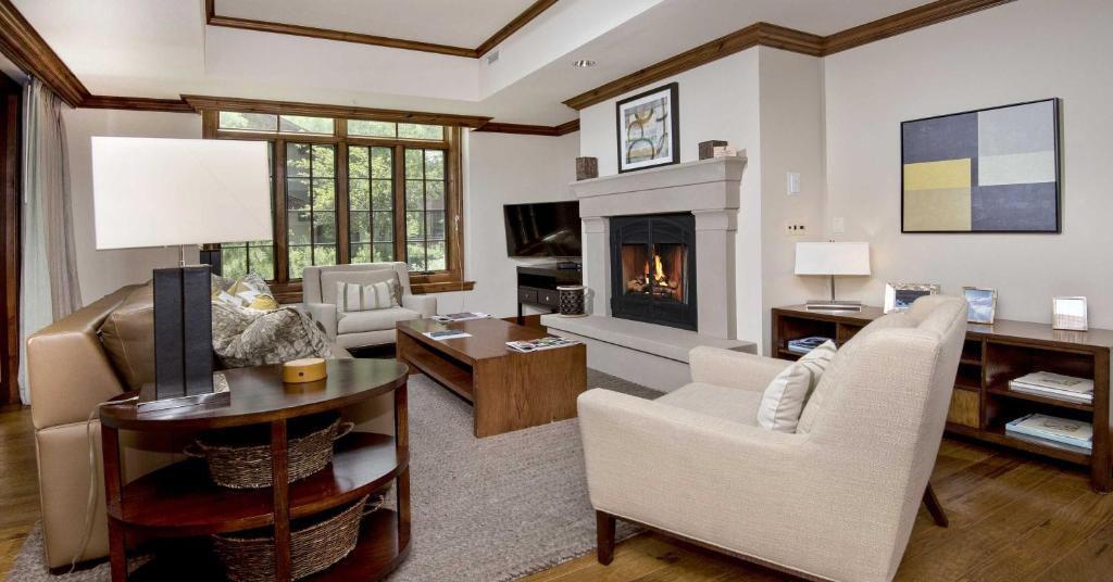 a living room with a fireplace and a couch at Ritz Carlton Residence #5 Condo in Vail