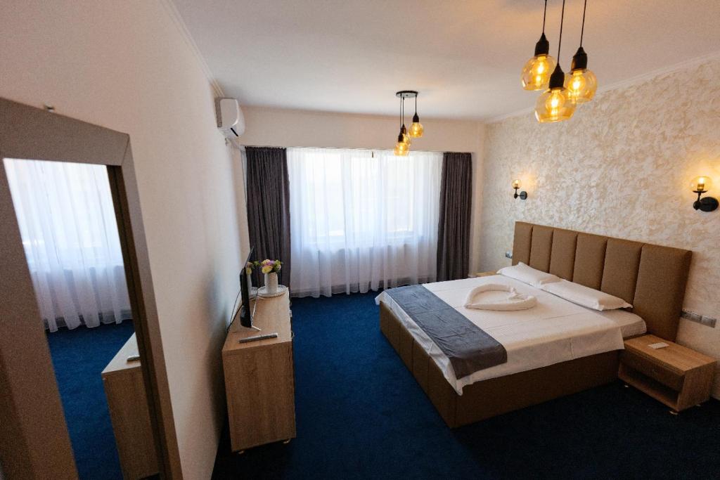 Postel nebo postele na pokoji v ubytování Villa Ovidiu