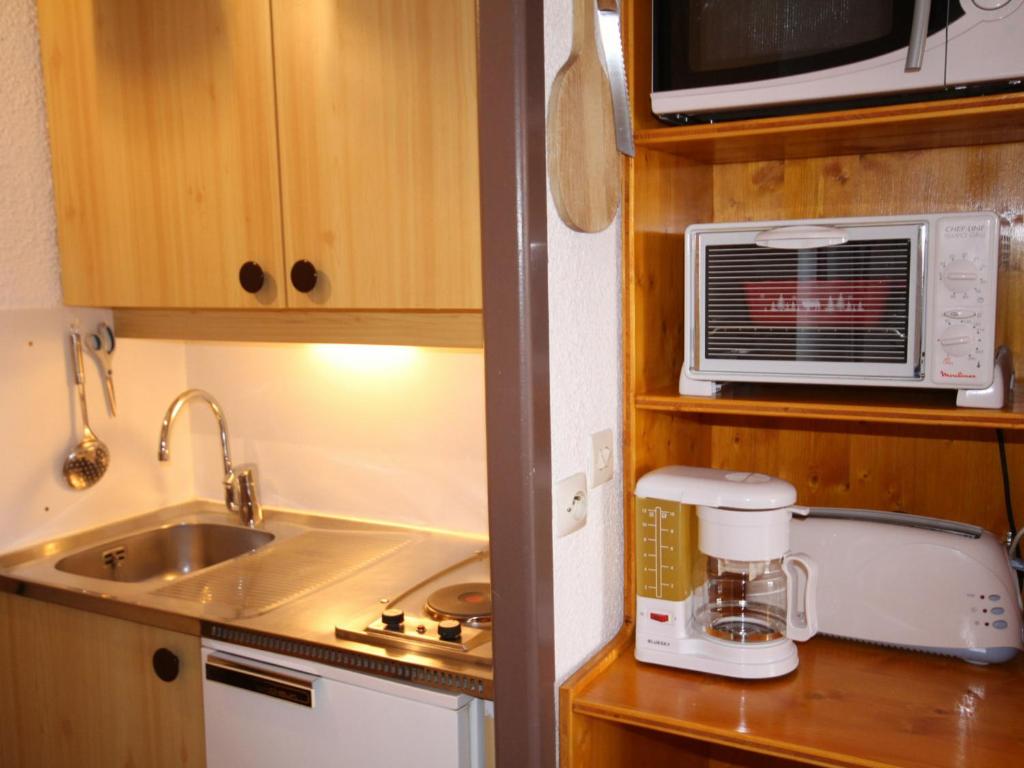 a small kitchen with a sink and a microwave at Studio Les Saisies, 1 pièce, 4 personnes - FR-1-293-173 in Les Saisies