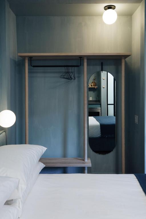 a bedroom with a bed and a mirror at Ode in Toronto
