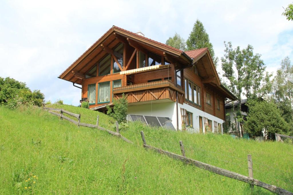 a house on top of a grassy hill at Haus Diamant by Schladming-Appartements in Schladming