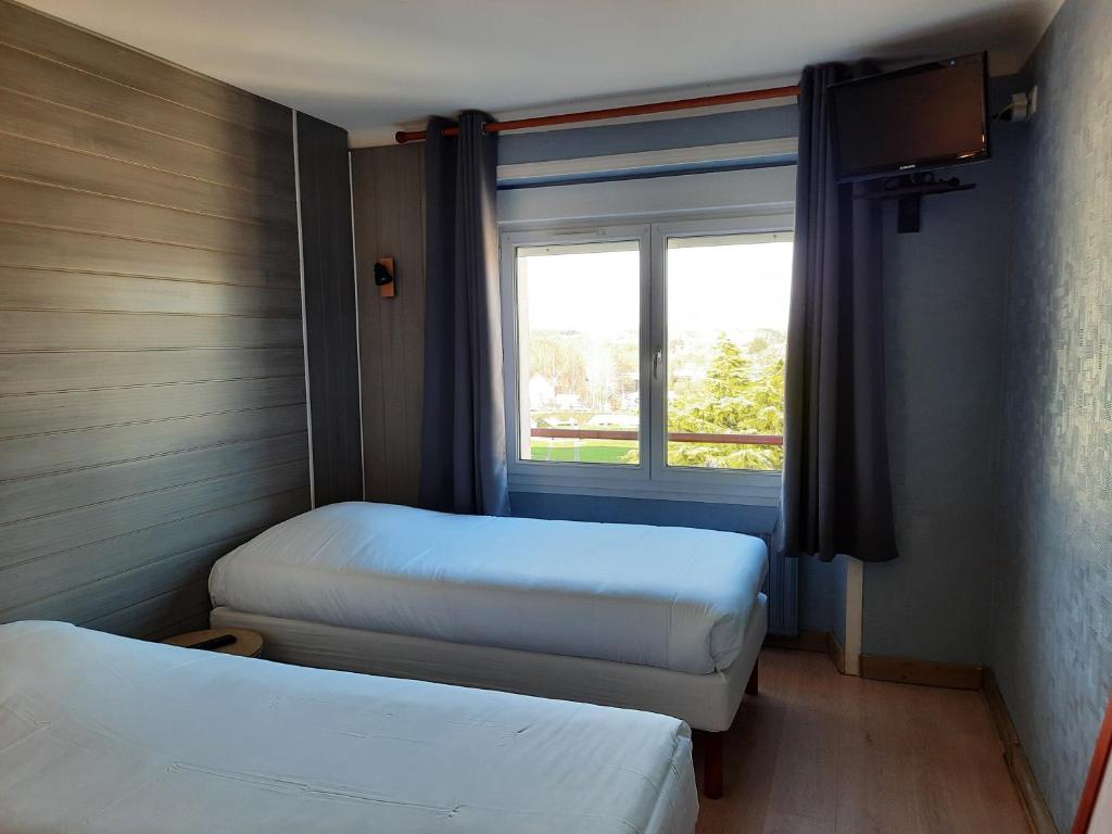 Postel nebo postele na pokoji v ubytování Hôtel des îles