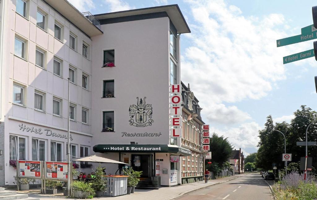 a building with a sign on the side of a street at Hotel Danner in Rheinfelden