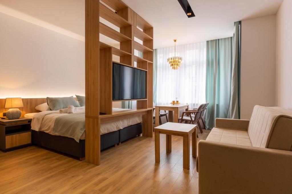 a bedroom with a bed and a living room at Apartmoon in Sarajevo