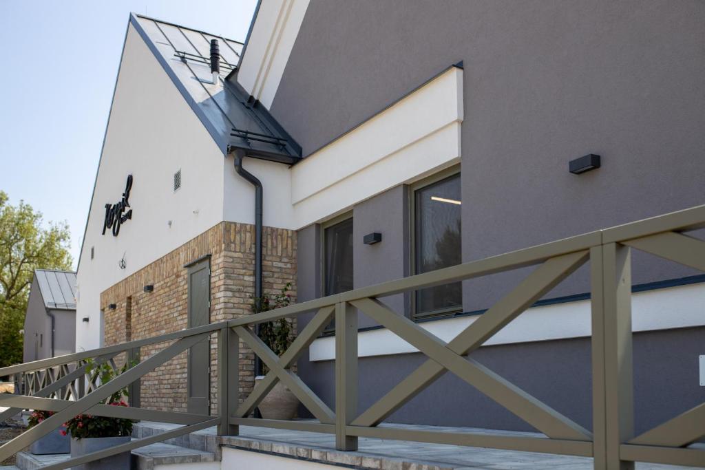 a balcony with a solarium on the side of a house at Kasnyik winery in Strekov