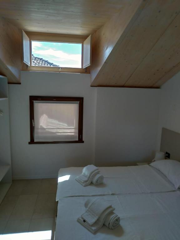 Łóżko lub łóżka w pokoju w obiekcie La Corte Room & Relax
