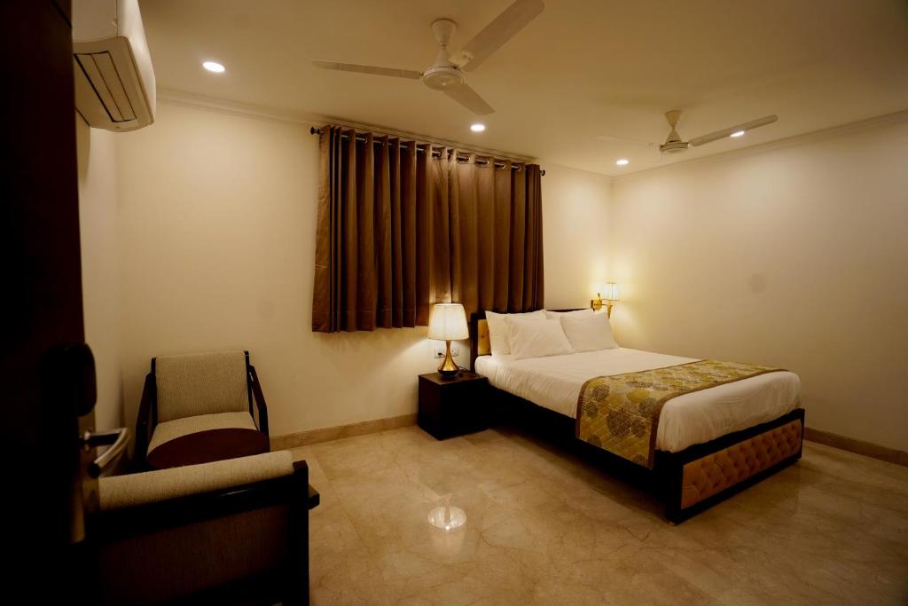 a hotel room with a bed and a window at Wongdhen House in New Delhi