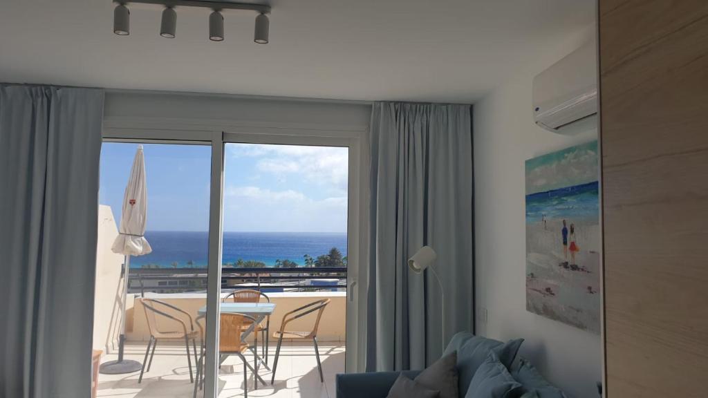 a living room with a view of the ocean at Holamigos Morro Jable in Morro del Jable