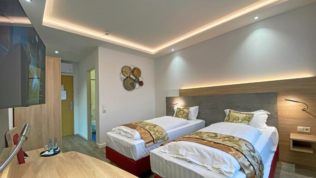 Postel nebo postele na pokoji v ubytování Hotel Danner