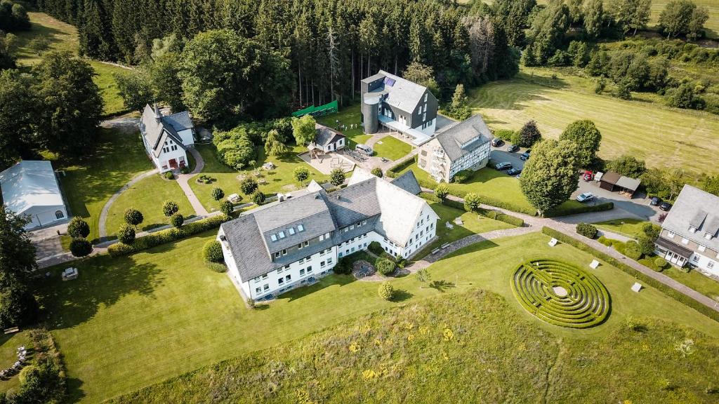 an aerial view of a large house on a field at St. Bonifatius in Winterberg