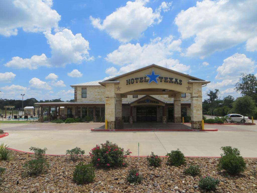 a hospital building with a star on the front at Hotel Texas Hallettsville in Hallettsville