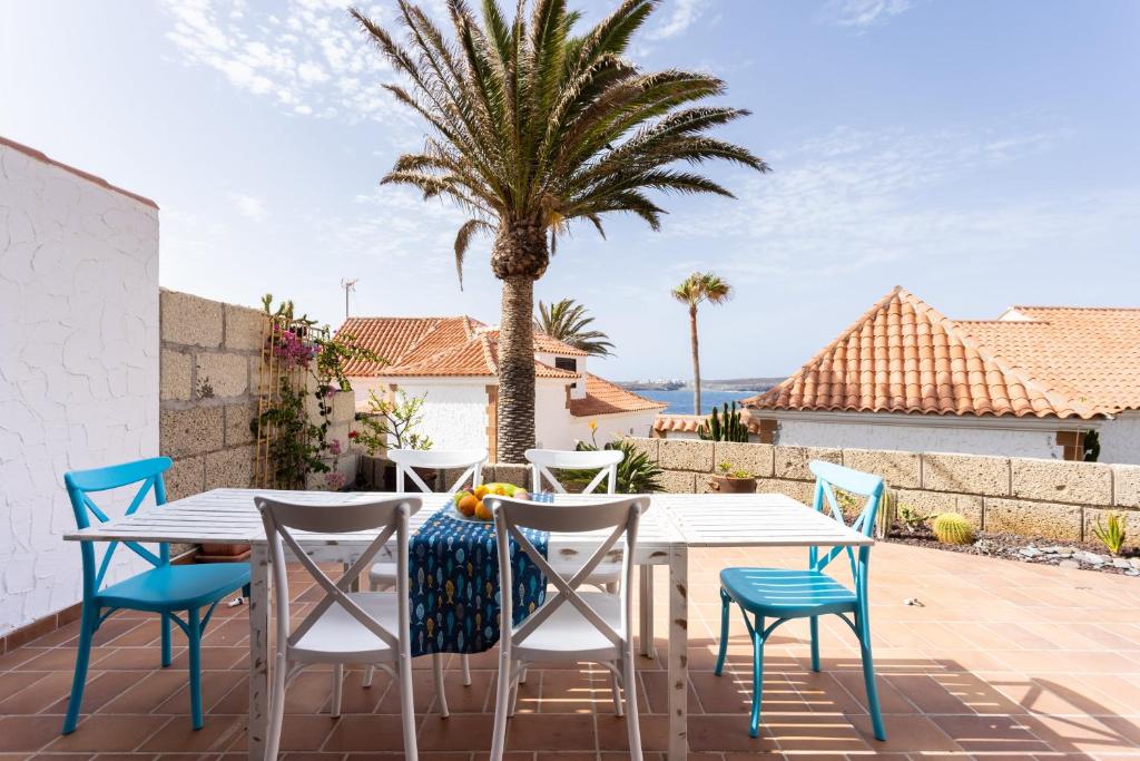 stół i krzesła na patio z palmą w obiekcie Casa Limon - Ocean View - BBQ - Garden - Terrace - Free Wifi - Child & Pet-Friendly - 2 bedrooms - 6 people w mieście Poris de Abona