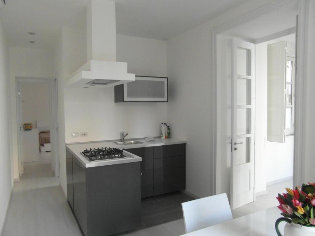 a kitchen with a sink and a stove top oven at Casa Umberto I in Catania