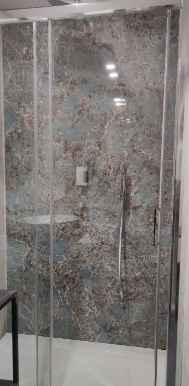 a shower with a glass door in a room at Panoramica dei Templi B&B in Agrigento