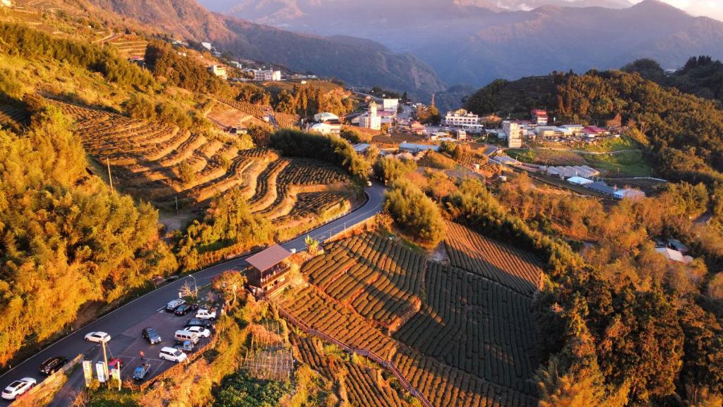 an aerial view of a village and a road in a vineyard at Tianyi Homestay in Fenqihu