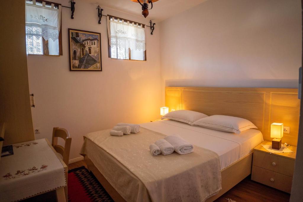 a bedroom with a bed with two towels on it at Hotel Borklad in Berat