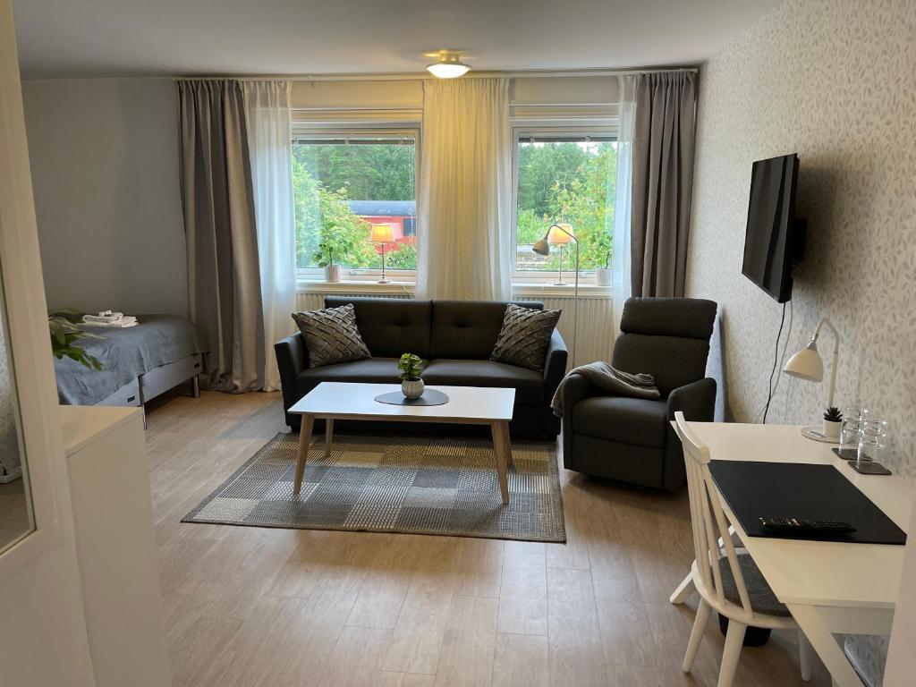 a living room with a couch and a table at Hotell Luspen in Storuman