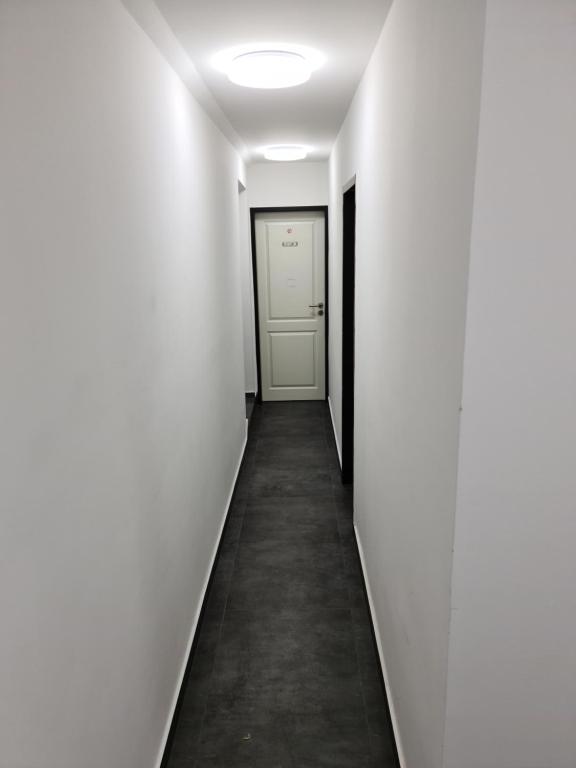 a hallway with white walls and a white door at Shop 23 in Hamburg