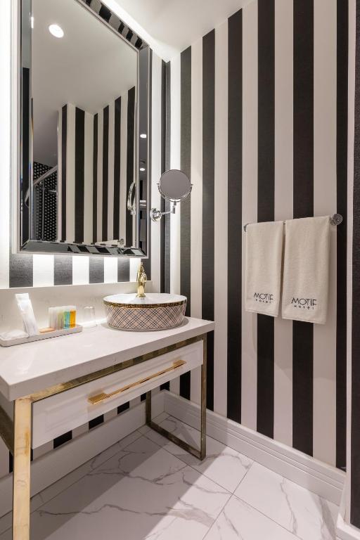 a bathroom with a sink and a mirror at Motif Hotel Çeşme in Çeşme