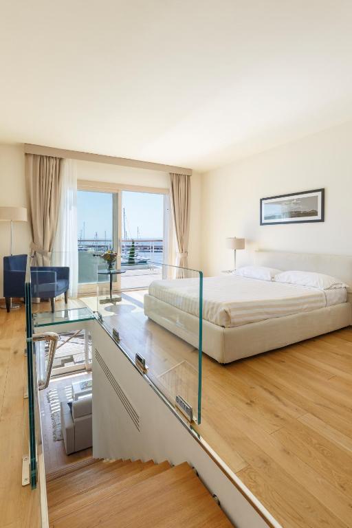 a bedroom with a bed and a glass table at Marina di Scarlino Resort in Puntone di Scarlino