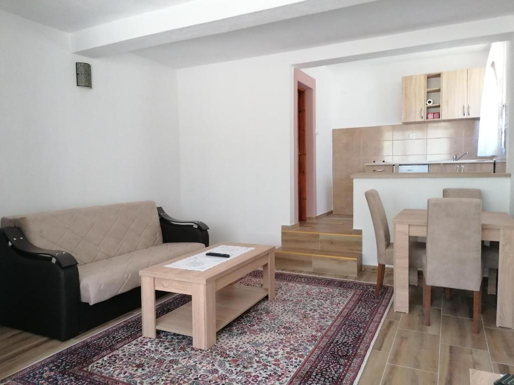 a living room with a couch and a table at Apartmani Tara i Zabojsko Dobrilovina in Mojkovac