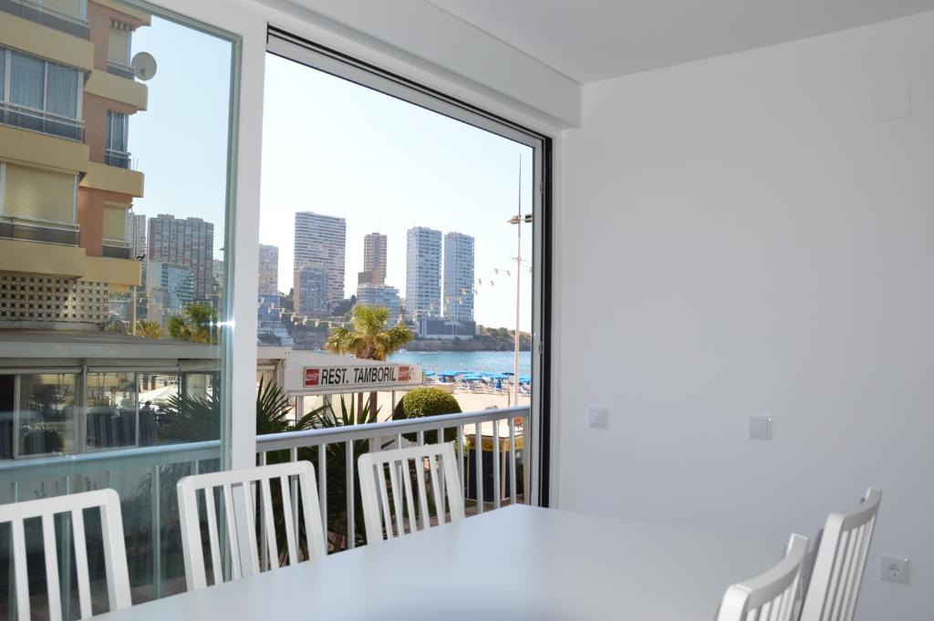 a balcony with a view of the beach and buildings at El Pato Primera Linea in Benidorm