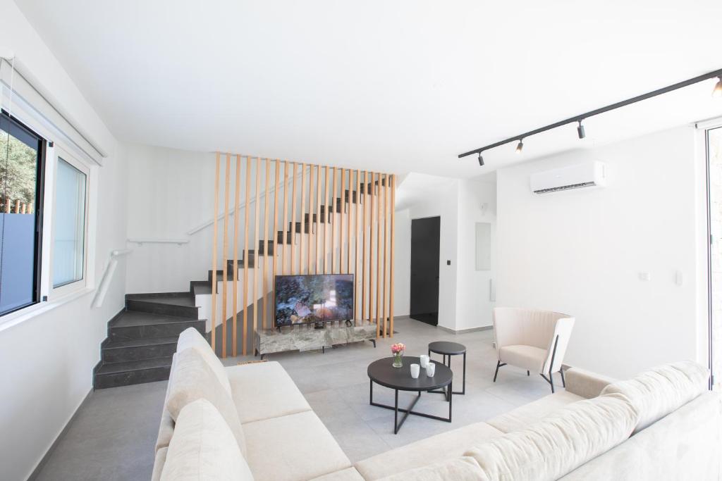 a living room with a couch and a fireplace at Kube Luxury Villas in Ayia Napa