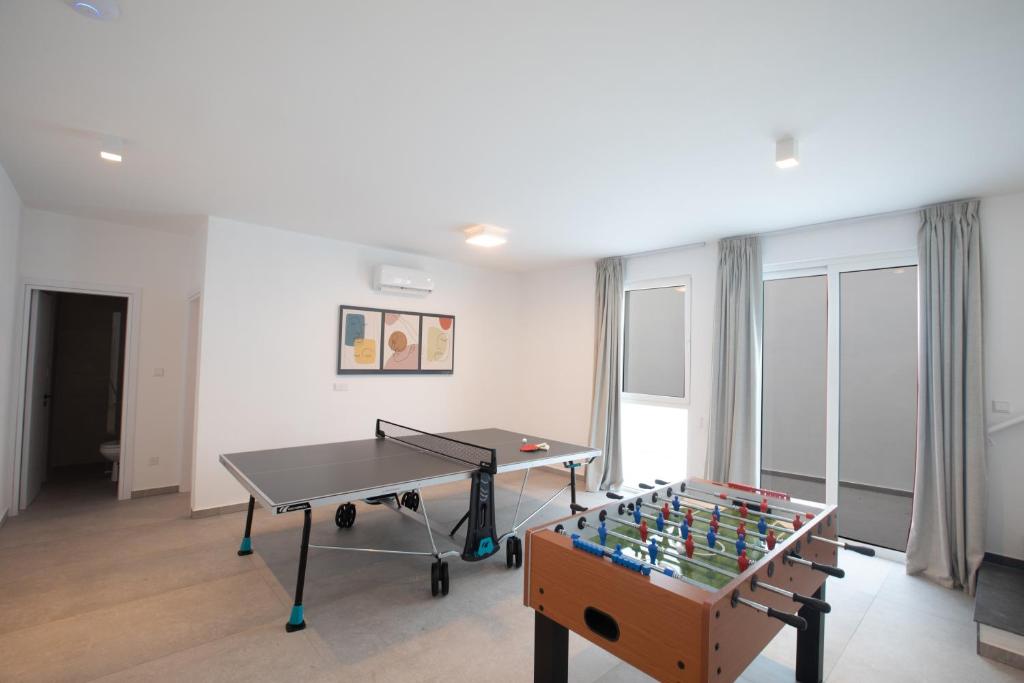 a living room with a ping pong table and a ping pong table at Kube Luxury Villas in Ayia Napa