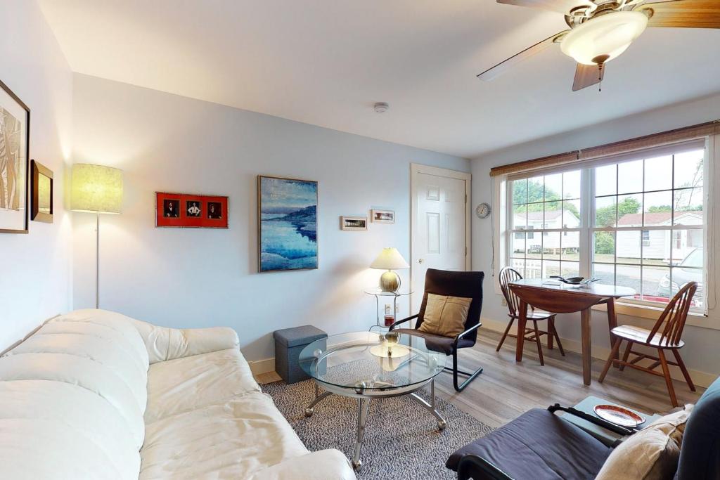 a living room with a couch and a table at Belle Of Maine Condo 106 in Wells