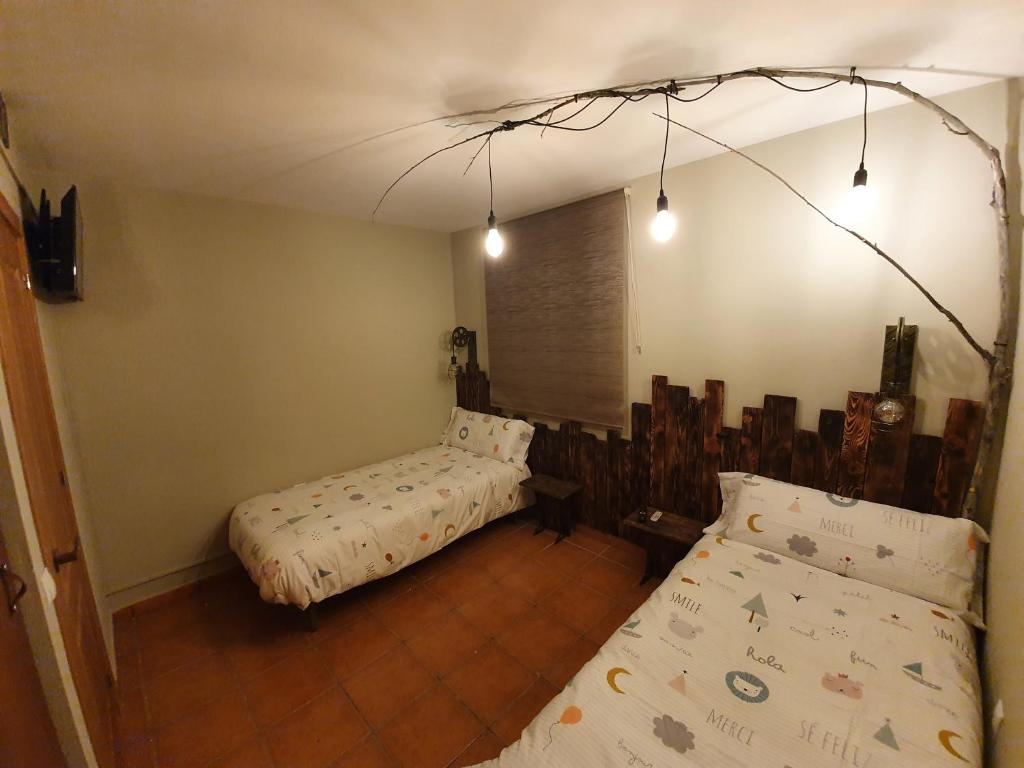 a room with two beds in a room at LA LEYENDA DEL CURAVACAS in Alba de los Cardaños
