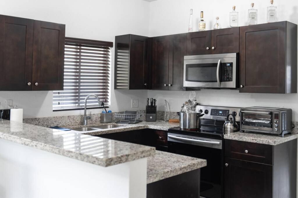 a kitchen with a microwave and a stove top oven at New house on the block near Miami Airport. in Miami
