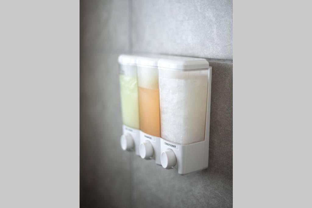 a soap dispenser hanging on a wall at New house on the block near Miami Airport. in Miami