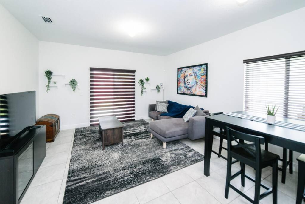 a living room with a table and a couch at New house on the block near Miami Airport. in Miami