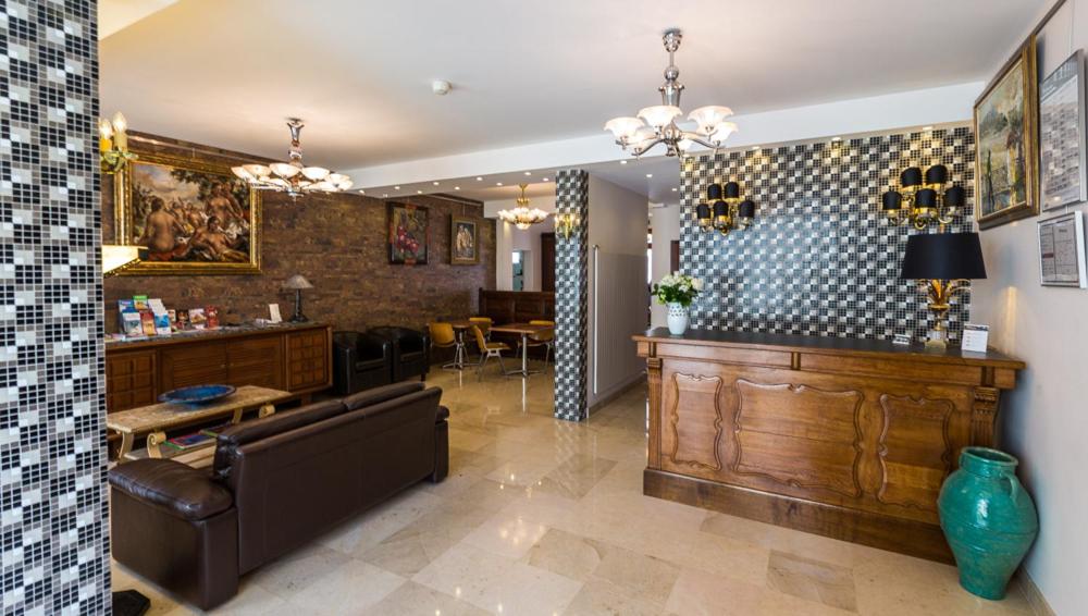 a living room with a couch and a table at Hotel Barnetche in Biarritz